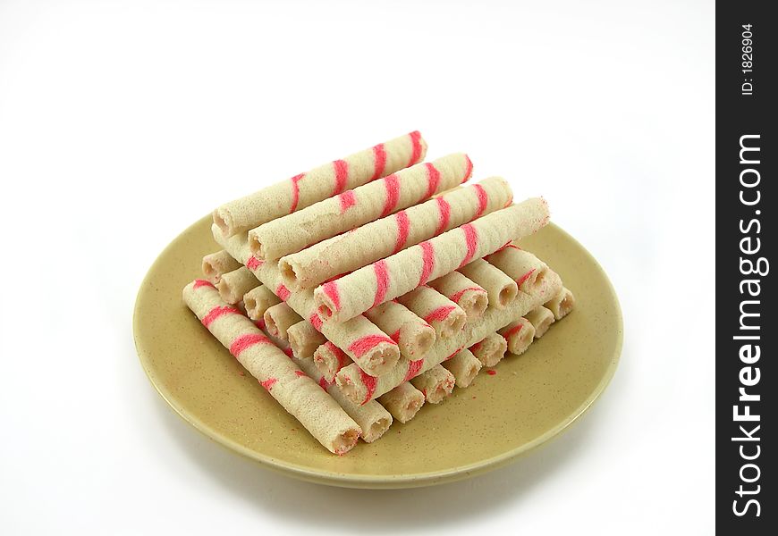 Beautiful cookies as sticks on a plate on a white background