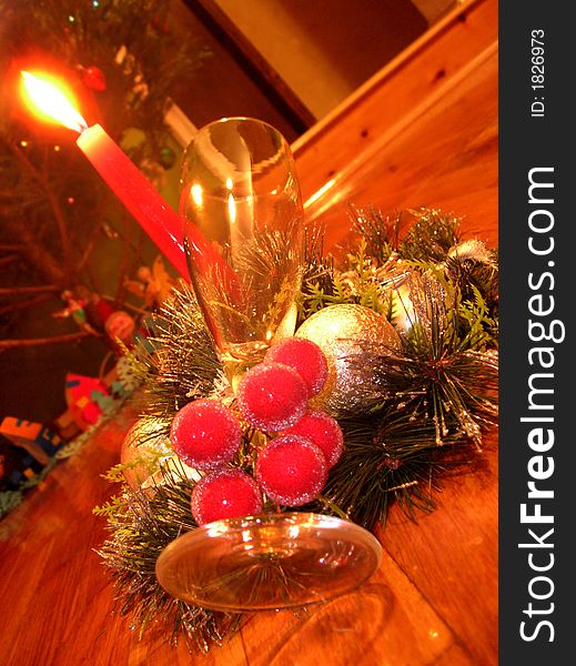 New-year decoration with a candle and glass for champagne. New-year decoration with a candle and glass for champagne