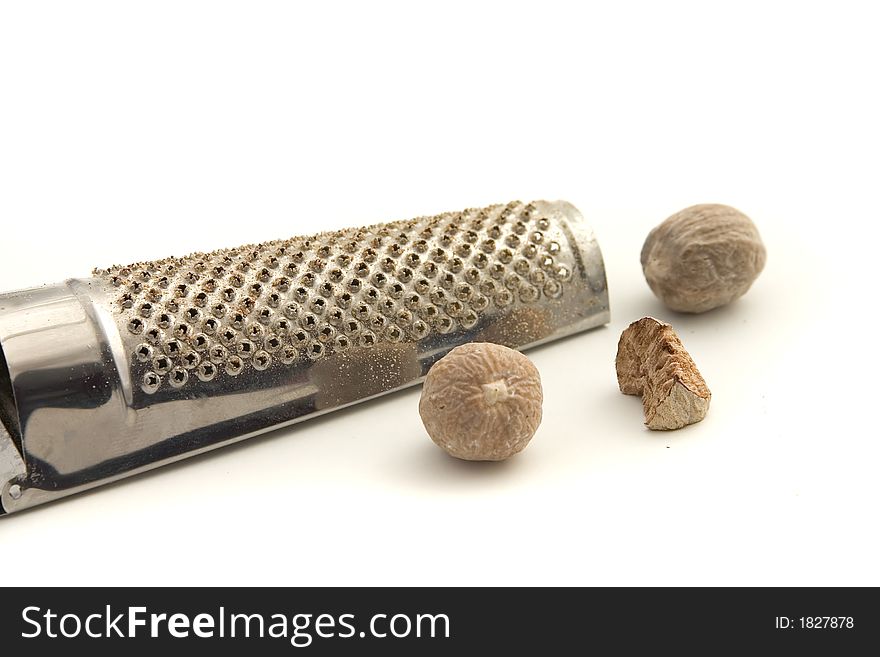 Nutmeg and grater isolated over white