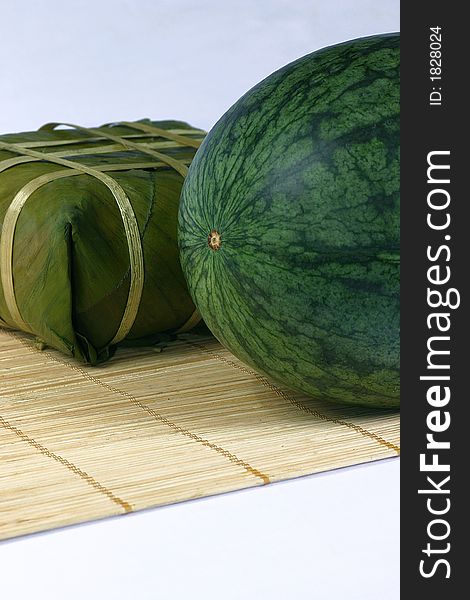 Fresh water melon and rice cake on the rattan background