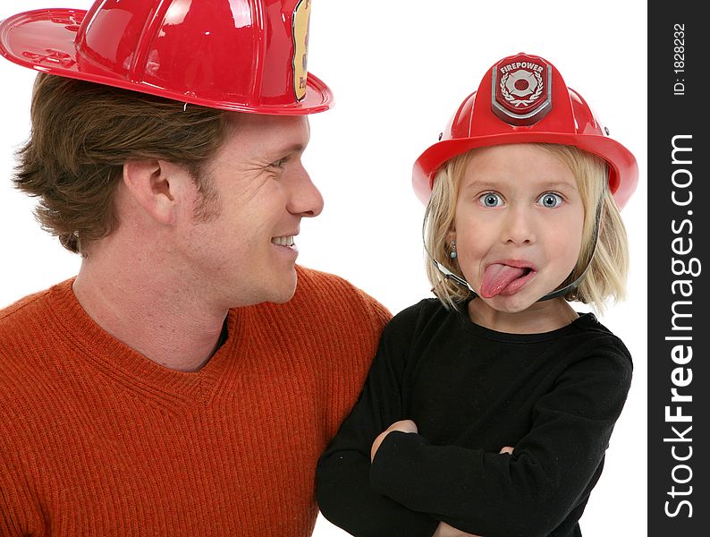 Adorable five year old girl with father. Making faces and wearing fire figher hat. Adorable five year old girl with father. Making faces and wearing fire figher hat.