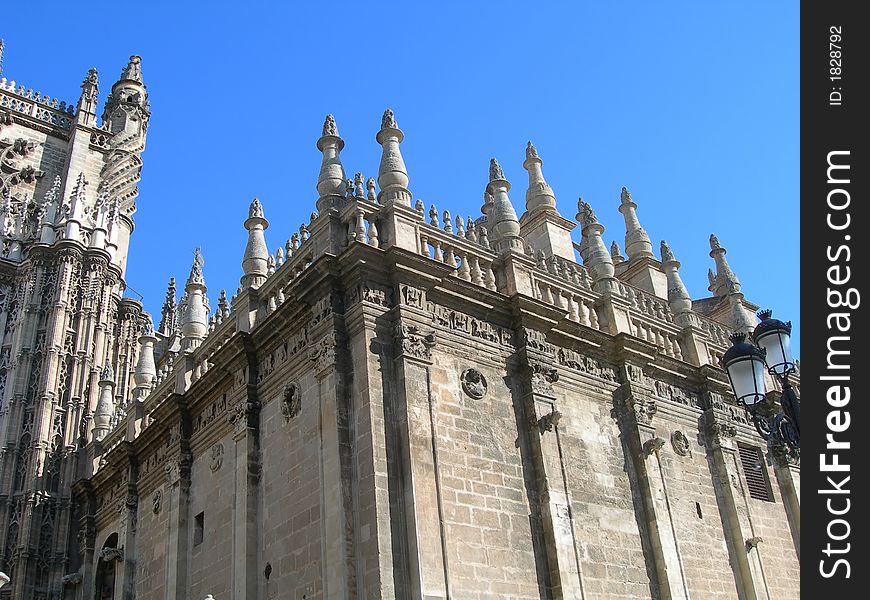 Detail of Catholic cathedral portal against clear blue sky in Spain. Detail of Catholic cathedral portal against clear blue sky in Spain