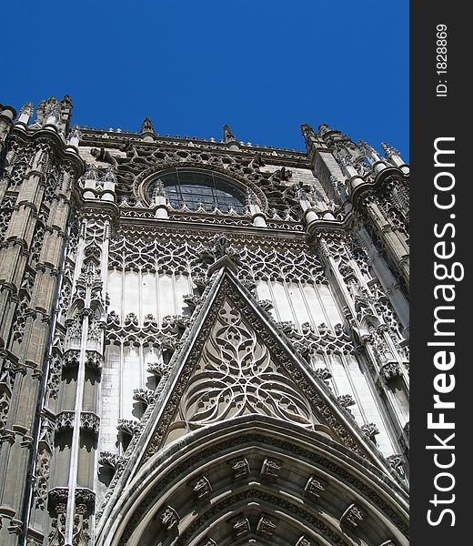 Detail of Catholic cathedral portal against clear blue sky in Spain. Detail of Catholic cathedral portal against clear blue sky in Spain