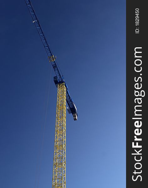 Crane on a dark blue sky. Crane on a dark blue sky
