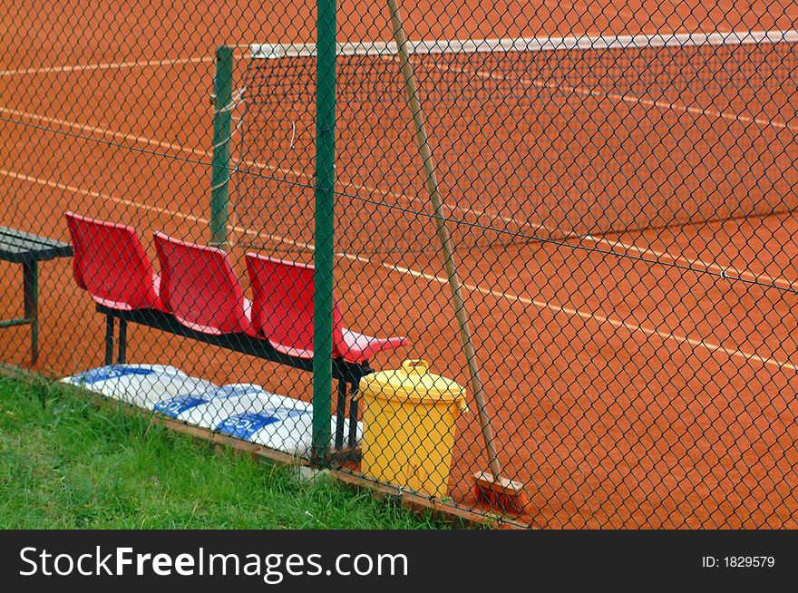 White Lines on the tennis playground and tree red seeds  behind the wire