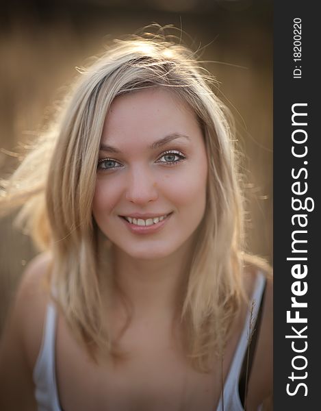 Portrait of a beautiful blonde woman with long hair and a smile