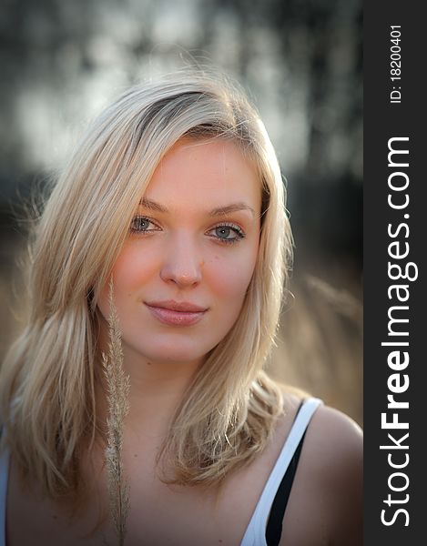 Portrait of a beautiful blonde woman with long hair and a smile