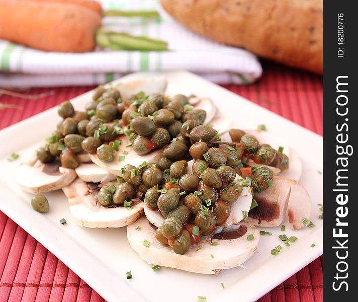 Some fresh mushrooms with capers