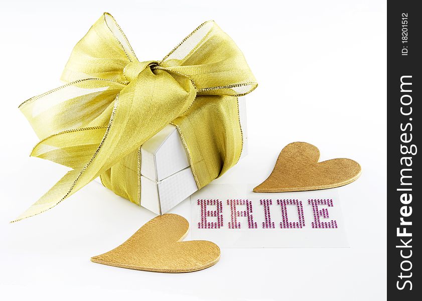White jewelry box with gold ribbon, 2 gold hearts, and bride shown in pink lettering on white background. White jewelry box with gold ribbon, 2 gold hearts, and bride shown in pink lettering on white background