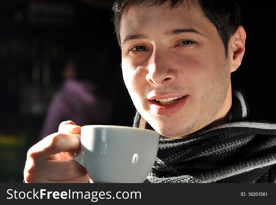 Young man enjoying a cup of coffee. Young man enjoying a cup of coffee