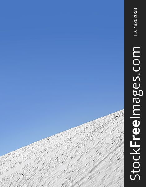 Unique white color sand dunes against blue sky background