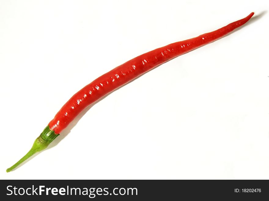 A red chili on a white background,. A red chili on a white background,