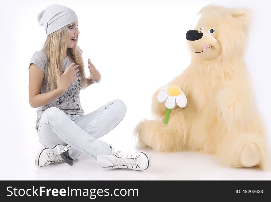 Emotional, glamour girl with a toy on a white background