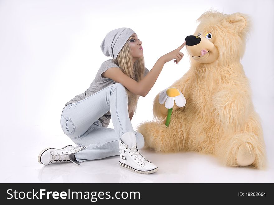Emotional, glamour girl with a toy on a white background