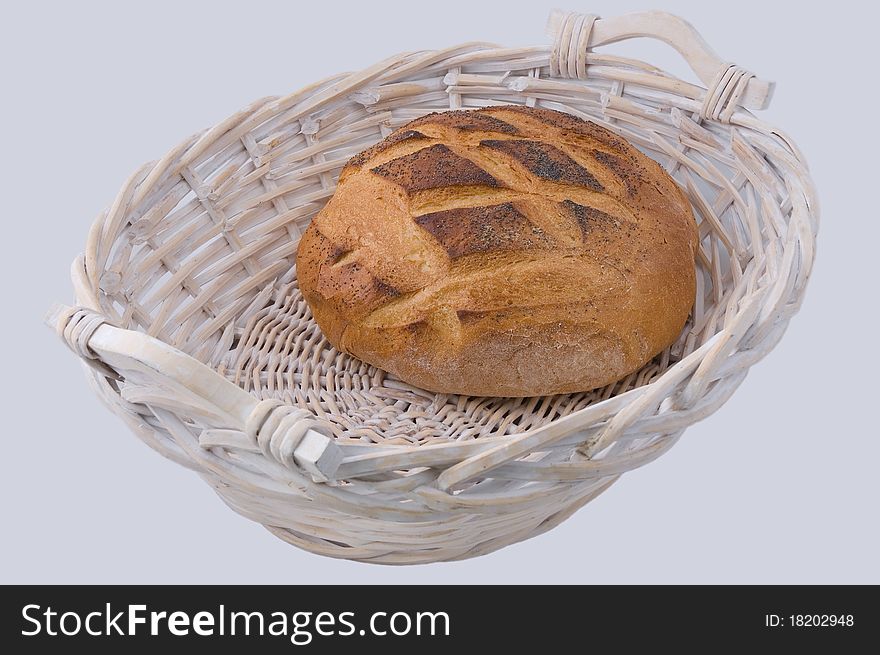 Round loaf of bread in wicker basket. Round loaf of bread in wicker basket