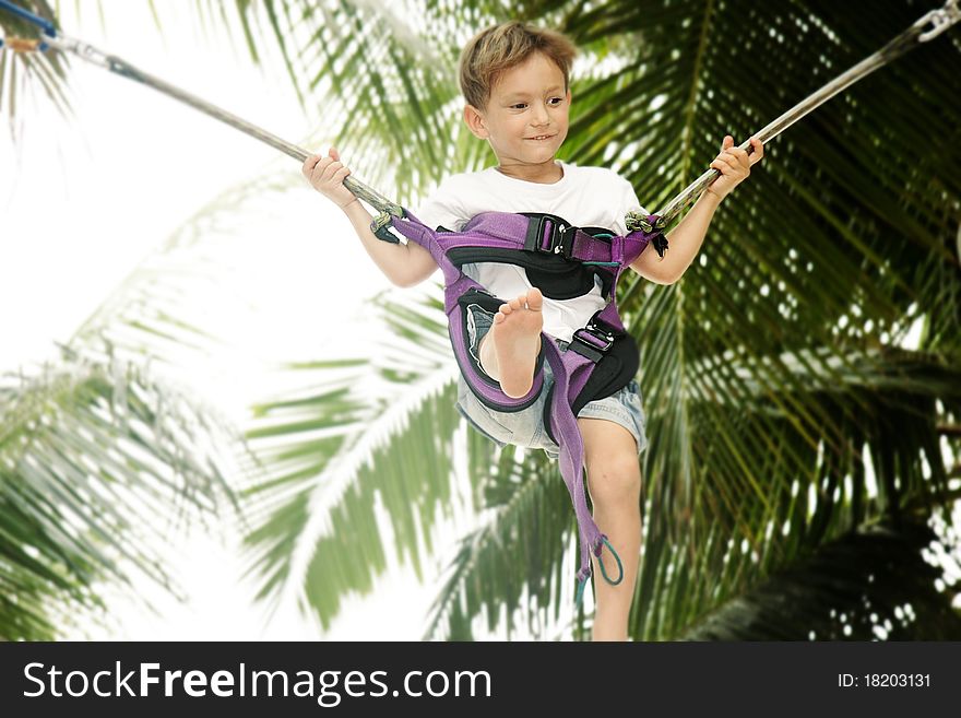 Young boy jumping bungee on natural background