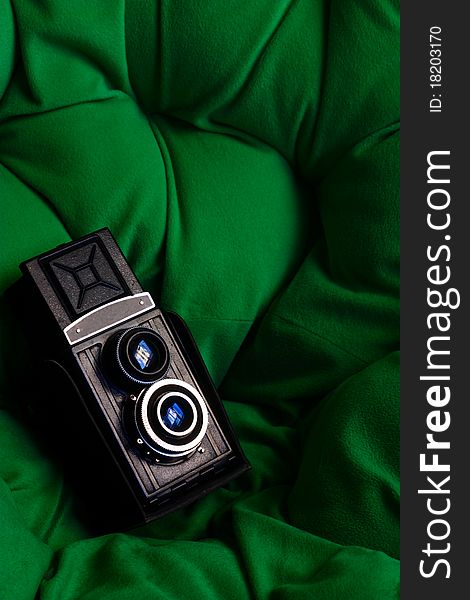 An old twin lens reflex camera on a green background. An old twin lens reflex camera on a green background