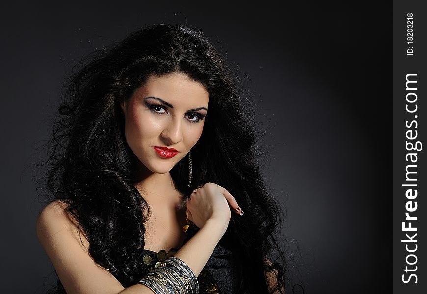 Beautiful woman with long black healthy hair in arabic traditional clothes