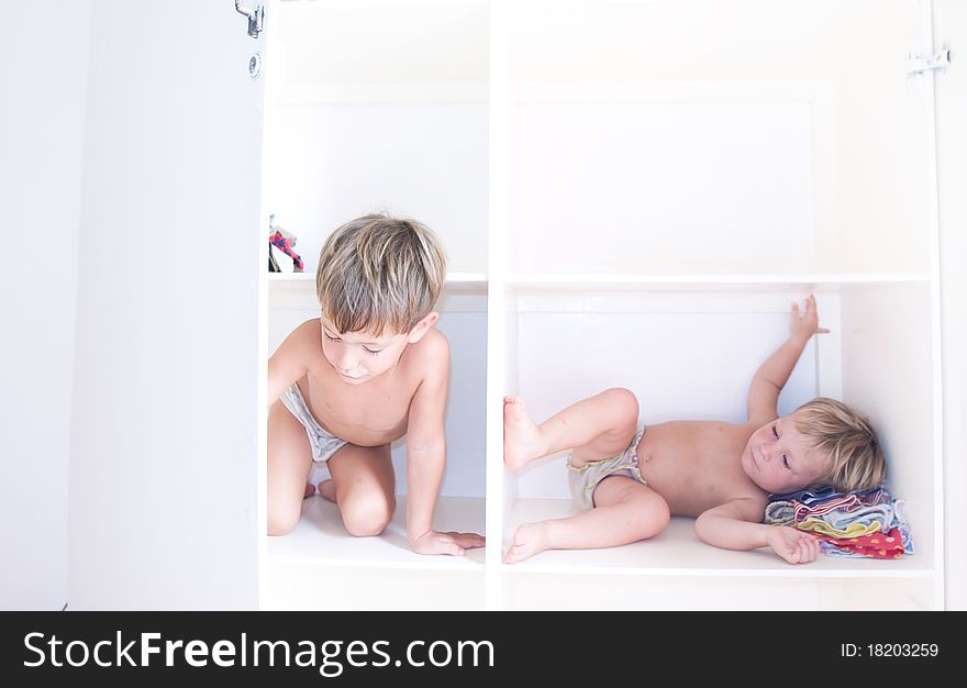 Two children on book shelves. Two children on book shelves