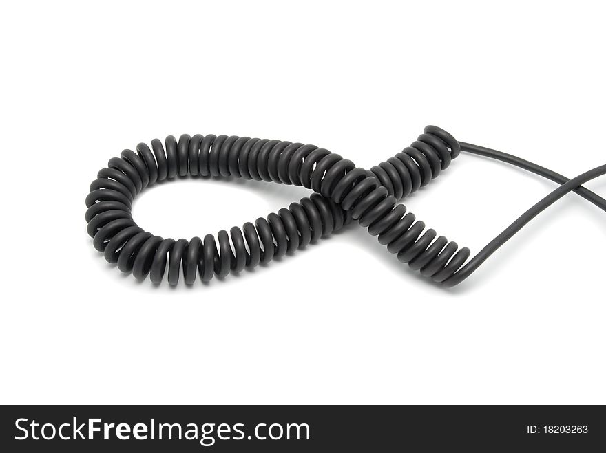 Black telephone cord in the form of a spring. On a white background