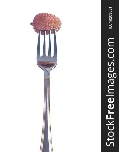 Lichee fruit on a fork on white background. Lichee fruit on a fork on white background