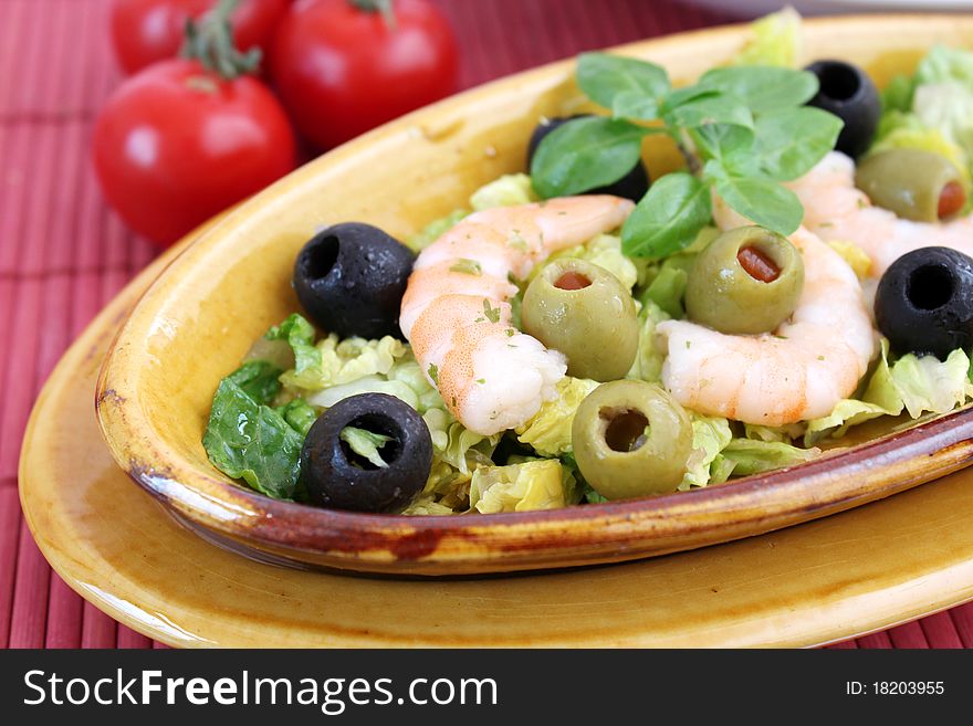 A fresh salad with olives and prawns