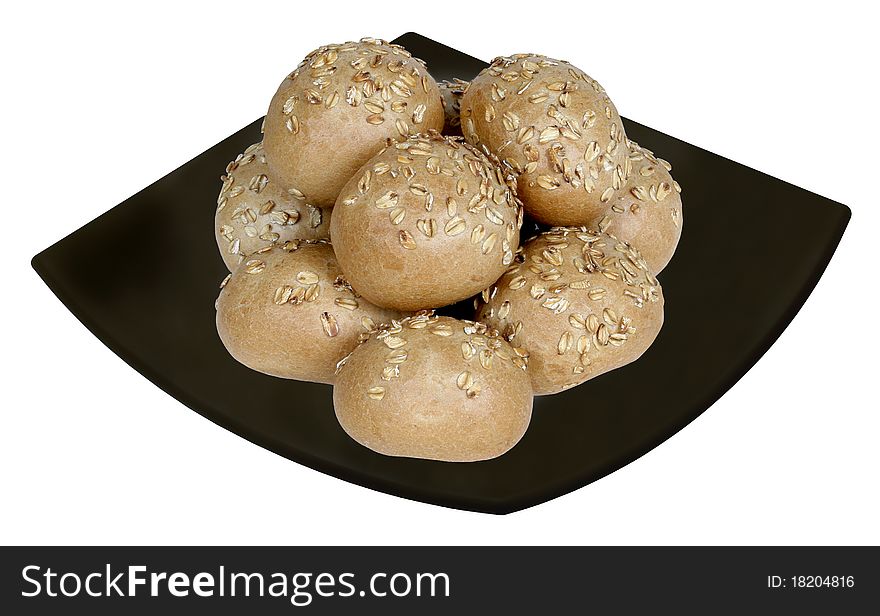 Cereal bread loaves in black ceramic plate, isolated on white. Clipping path included.