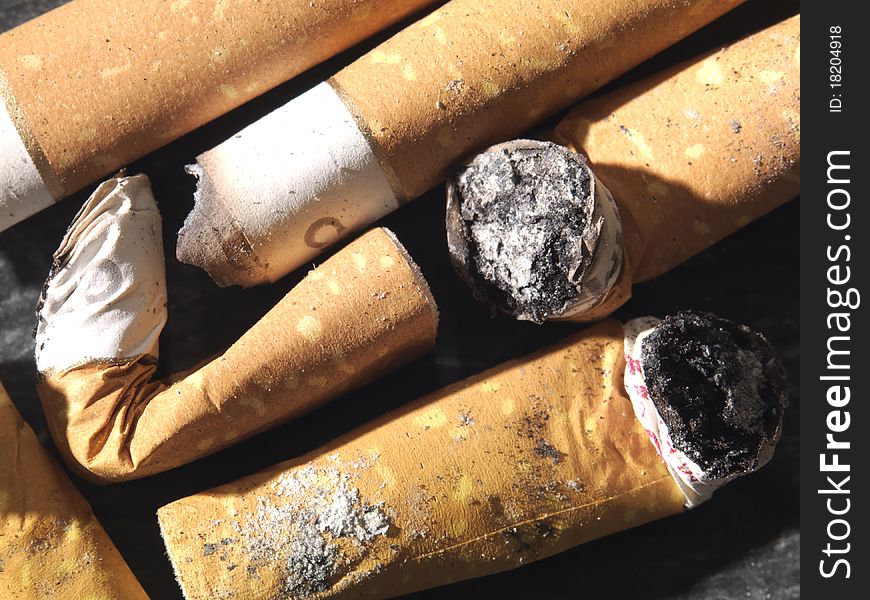 Smoked cigarette-end with ash. Smoked cigarette-end with ash