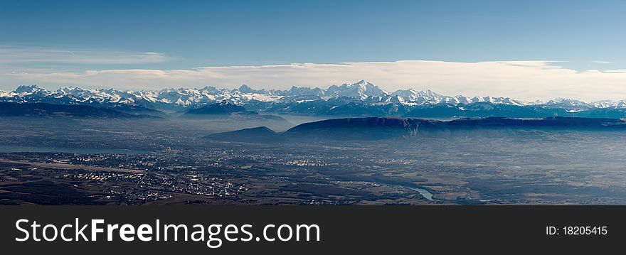 A panoramic bird-eye view on snow Mont-Blanc mountain chain and Geneva valley, XXL size. A panoramic bird-eye view on snow Mont-Blanc mountain chain and Geneva valley, XXL size