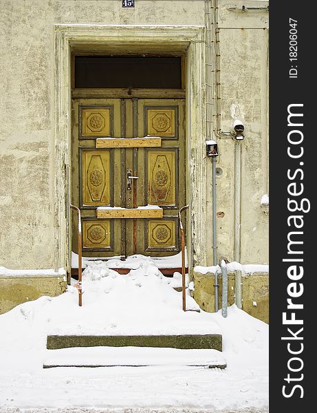 Abandoned old building with snowed in and decayed front door. Abandoned old building with snowed in and decayed front door