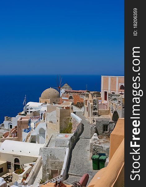 Beautiful view on the street in Santorini, Oia. Aegean sea in a background, Greece. Beautiful view on the street in Santorini, Oia. Aegean sea in a background, Greece.