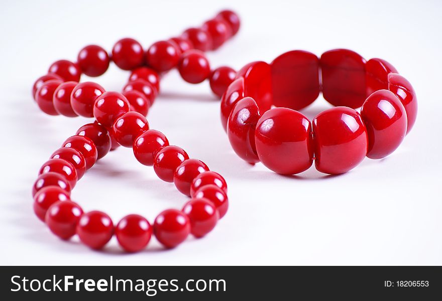 Red beads and bracelet on white