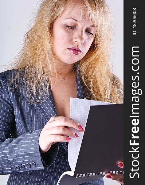 Girl reading a notebook in office