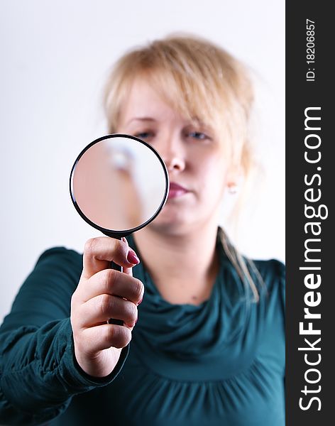 Young girl looking through magnifying glass