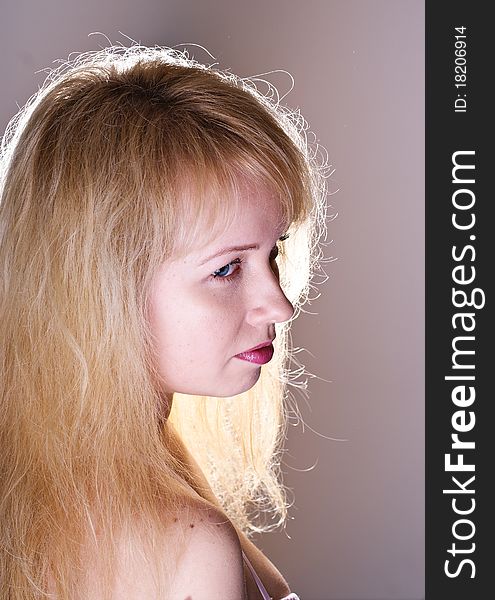 Portreit attractive blond girl on grey background