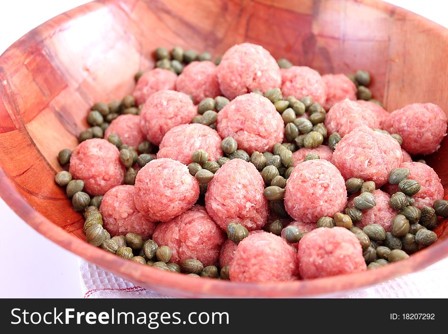 Some fresh meatballs with capers in a bowl