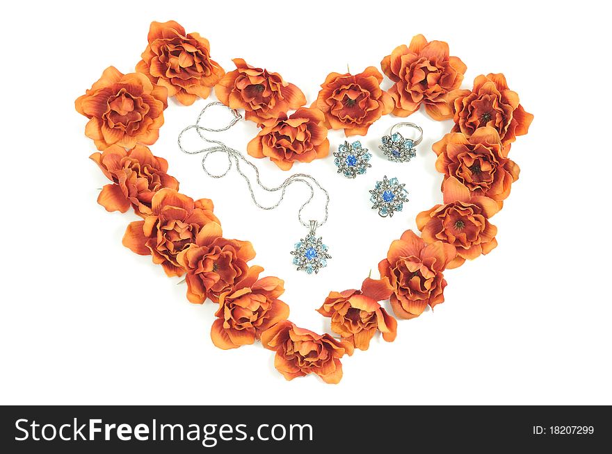 Beautiful jewelry set and  flowers around in heart shape. Beautiful jewelry set and  flowers around in heart shape