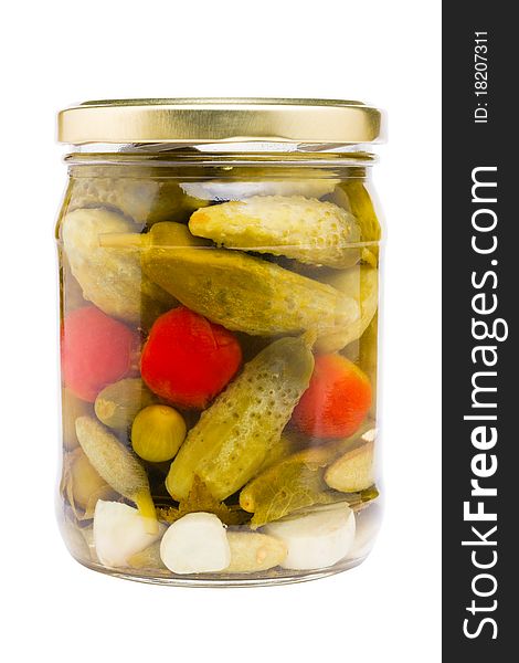 Preserved cucumbers and tomatoes, glass jar with pickled vegetables