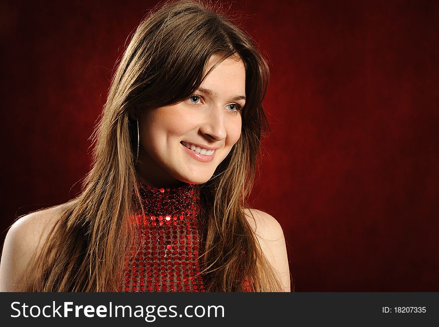Portrait of the beautiful woman on a red background