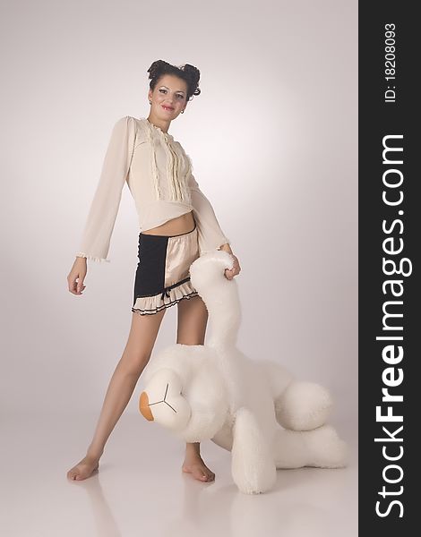 The beautiful model with a bear in hands