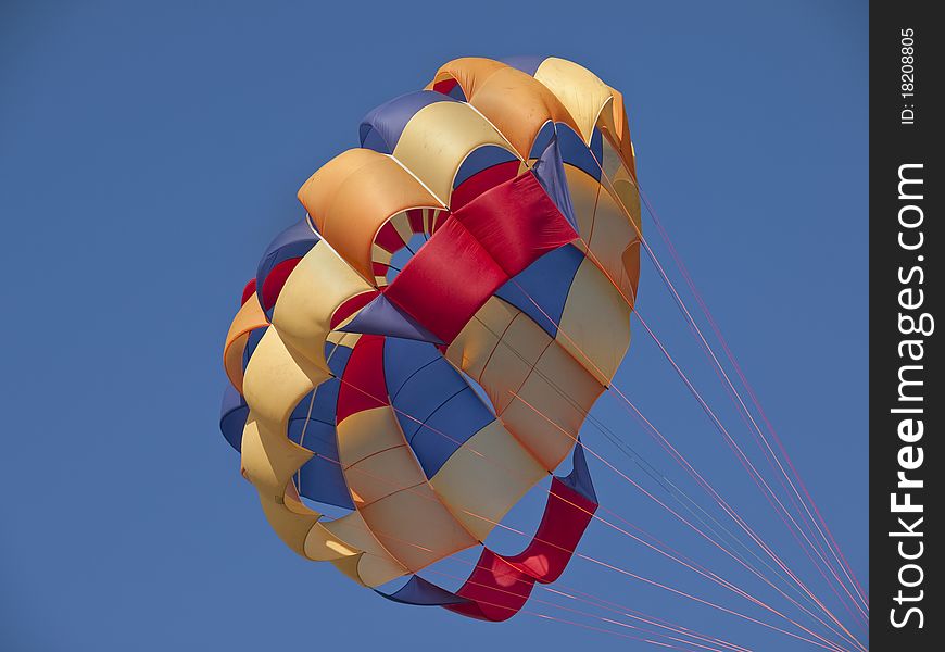 Multi-coloured parachute against the sky. Multi-coloured parachute against the sky
