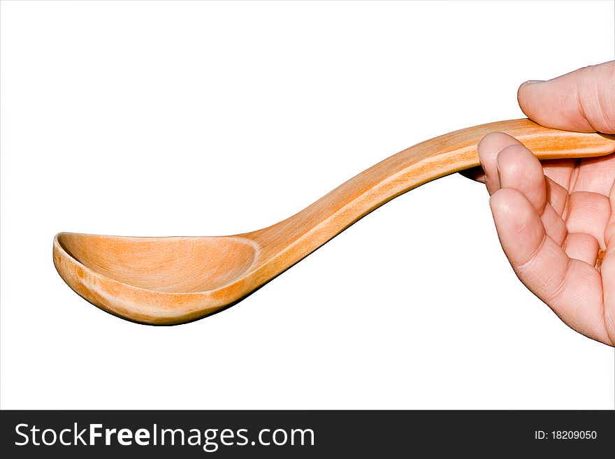 Wooden spoon in hand on white background