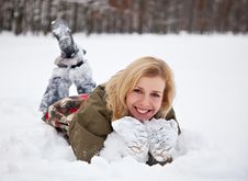 A Woman Is Lying At The Snow In The Park Royalty Free Stock Photo