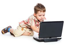 A Cute Boy Is Typing On A Laptop Stock Image