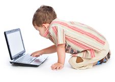 A Cute Boy Is Typing On A Laptop Royalty Free Stock Photo