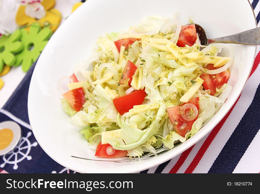 Fresh salad with tomatoes and cheese in a bowl
