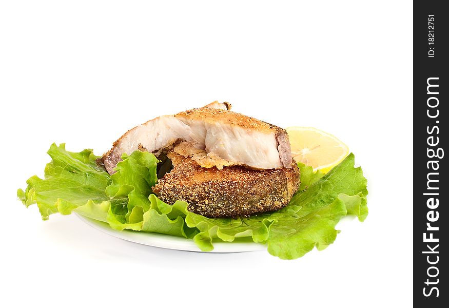 Fried fish with lettuce on white background
