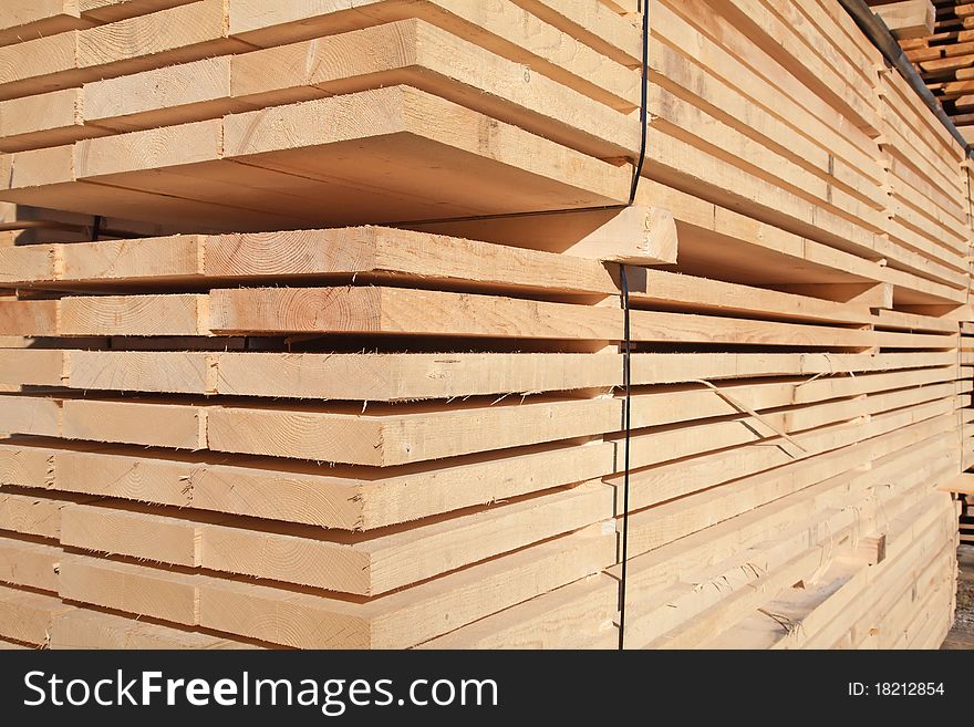 Stack of new wooden studs at the lumber yard. Stack of new wooden studs at the lumber yard