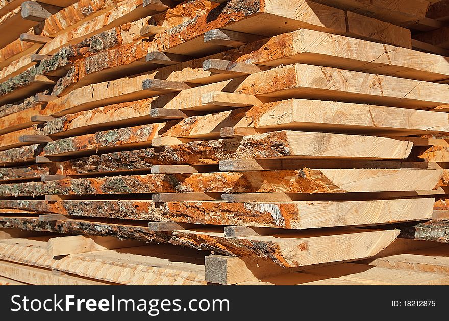 Stack of new wooden studs at the lumber yard. Stack of new wooden studs at the lumber yard