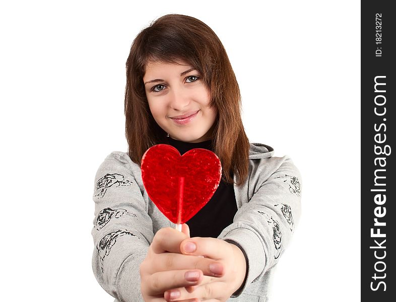 Girl with a heart-shaped candy on a white background